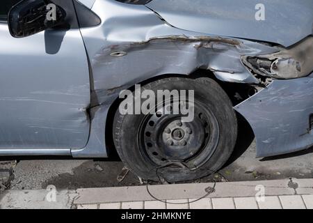 Dented Car side. Transport Accident Crashed metall on private car. Car insurance concept. Blue Metallic color Stock Photo