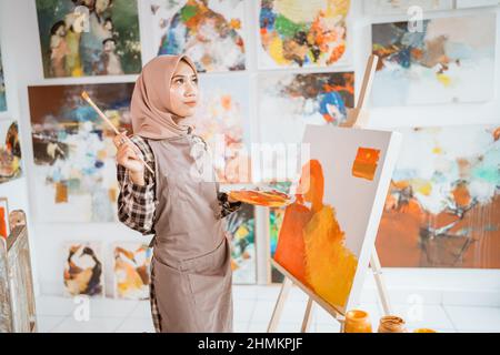 muslim artist painter thinking about what to paint Stock Photo