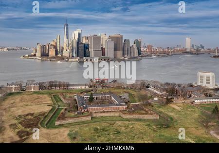 Aerial view of historic brick Fort Jay on Governors Island guarding the Hudson river in New York with views of the sky scrapers of the financial distr Stock Photo