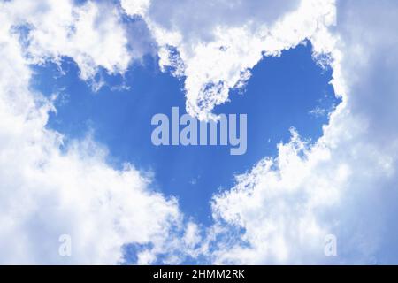 Fluffy Heart Shape Frame Cumulus Clouds on Vivid Blue Sky for the Concept of Valentine's Day Stock Photo