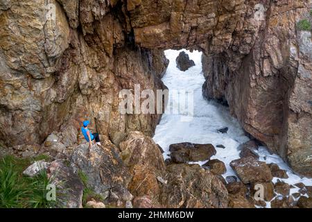 Tan Phung Fishing Village, Phu My, Binh Dinh, Vietnam - January 1, 2022: Tourists enjoy the experience at 'Mui Vi Rong' with a rock cave connecting to Stock Photo