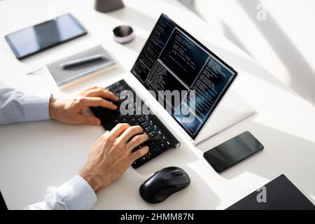 Computer Programmer Writing Program Code On Computer In Office Stock Photo