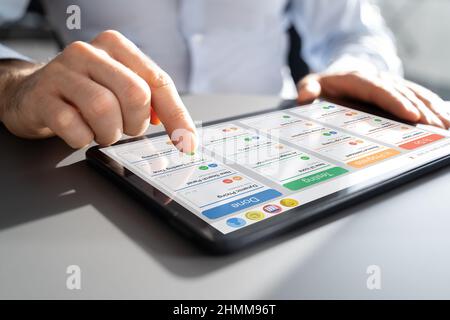 Scrum Project Manager Using Scrum Board Scheduling Software Stock Photo