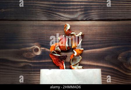 Dried pieces of mushroom fly agaric on table from package. Natural microdose, microgram of psychedelic, therapeutic narcotic substance in poisonous Am Stock Photo