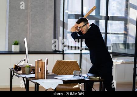 Sad Angry Business Manager In Office With Baseball Bat Stock Photo