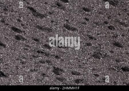 Black grey sponge textured background. Foam rubber background. Stock Photo