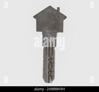 Close up photo of house shaped key on isolated background. Stock Photo