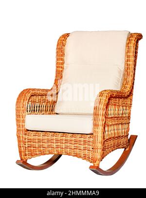 Wicker rocking chair with soft fabric upholstery in beige color isolated on a white background. Stock Photo