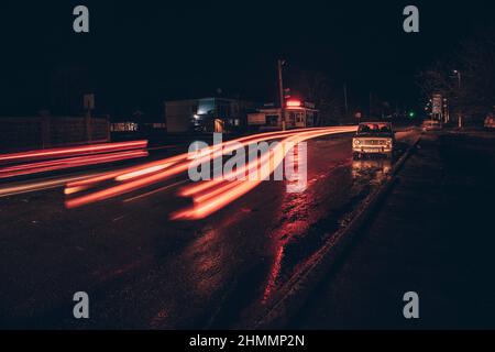 Red and white lights from passing cars. Night highway. Stock Photo