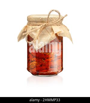 Tomatoes in the jar. Homemade sun dried tomatoes. temporary closing-down. Summer and autumn canned food. conserve with spices and vegetables. Isolated Stock Photo