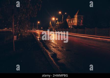 Red and white lights from passing cars. Night highway. Stock Photo