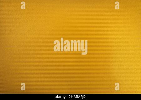 Golden color cardboard texture. Golden color glitter with light. Stock Photo