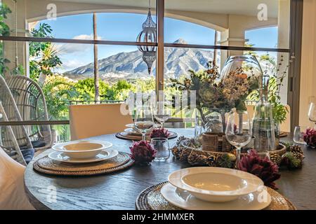 a view from a beautiful dining table inside a beautiful villa overlooking the mountains of Costa del Sol Stock Photo