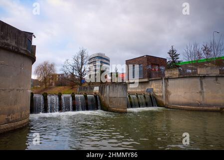 Svitava river with weir in Blansko near the railway station. In the background a modern office building. High quality photo Stock Photo