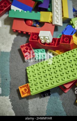 Lego Duplo mix of plastic toy bricks laying on a carpet. Stock Photo