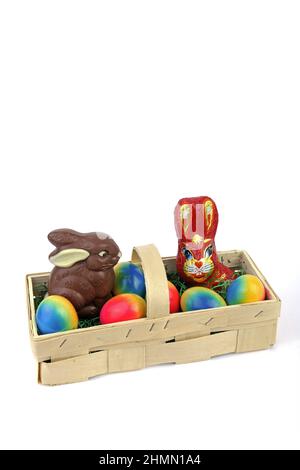 Easter basket with two chocolate Easter bunnies and dyed eggs Stock Photo