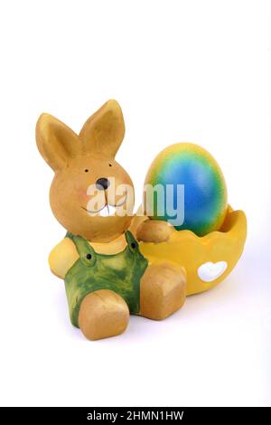 egg cup with Easter bunny and brightly colored Easter egg Stock Photo