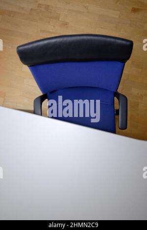 empty blue office chair at a writing desk Stock Photo