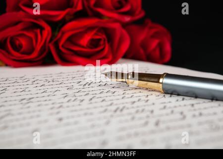 fountain pen on letter with text and red roses close up Stock Photo