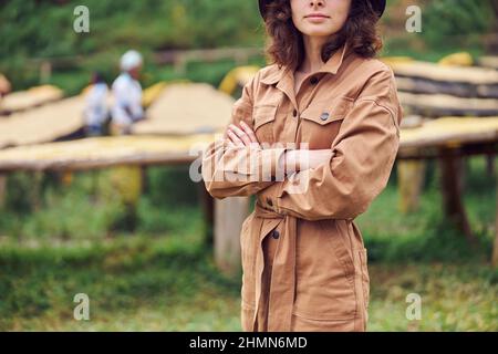 caucasian woman is standing in front of coffee washing station in eastern africa region Stock Photo