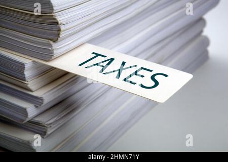 bookmark labeled taxes in the stack of documents close up Stock Photo