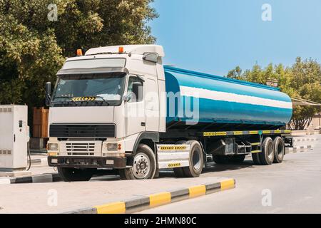 Water tank trailer unit, prime mover, refuel at gas and oil station in sunny summer day. Water tank trailer parked near oil station. Water tank Stock Photo