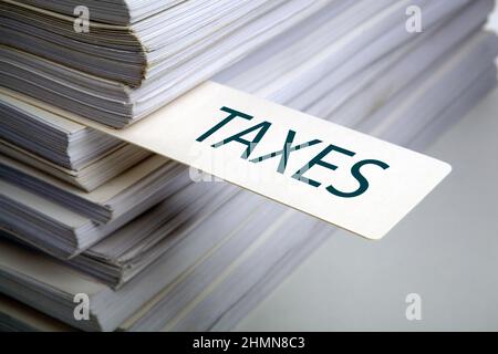 bookmark labeled taxes in the stack of documents close up Stock Photo