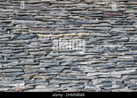 Background from a wall made of old slate slabs Stock Photo