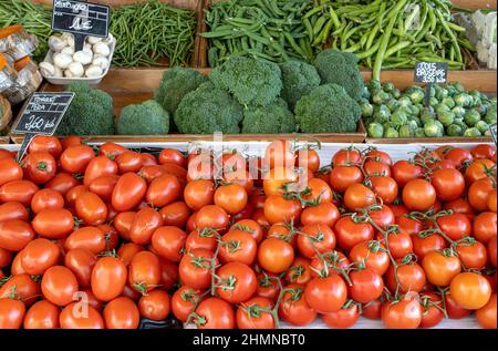 Tomatoes, broccoli and green peas for sale at a market Stock Photo