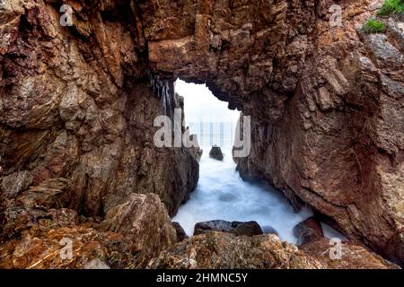 'Mui Vi Rong' with a rock cave connecting to the sea, a wild beauty in Tan Phung Fishing Village, Phu My, Binh Dinh, Vietnam Stock Photo