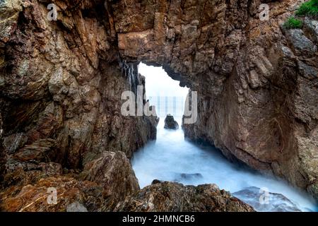 'Mui Vi Rong' with a rock cave connecting to the sea, a wild beauty in Tan Phung Fishing Village, Phu My, Binh Dinh, Vietnam Stock Photo