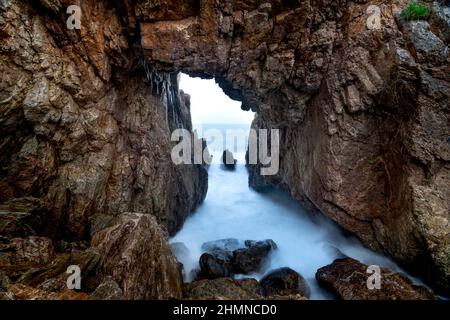 'Mui Vi Rong' with a rock cave connecting to the sea, a wild beauty in Tan Phung Fishing Village, Phu My, Binh Dinh, Vietnam Stock Photo