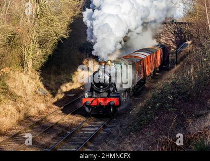 GWR locomotive 6990 Witherslack Hall with a goods train heading south on the Great Central Railway Stock Photo
