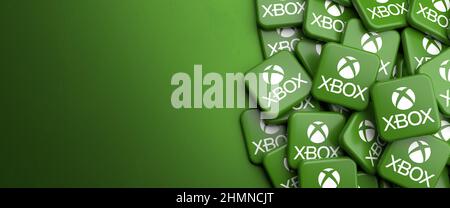 Logos of the home video game console Microsoft Xbox on a heap on a table. Copy space. Web banner format. Stock Photo