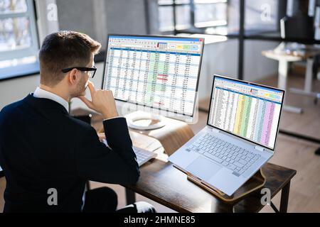 Analyst Working With Spreadsheet Business Data On Computer Stock Photo