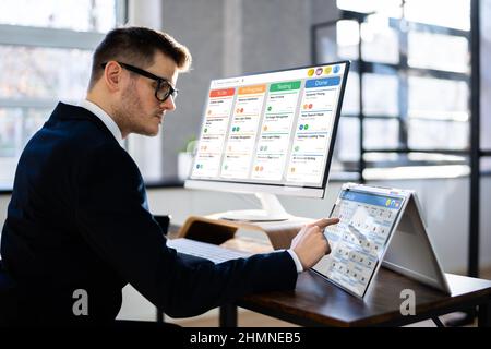 Gantt Tasks Schedule Chart On Computer In Office Stock Photo