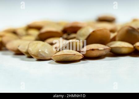 Isolated stack of uncooked lentils on white background - Dry beans - close-up - macro shoot. Stock Photo