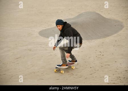 Vaduz, Liechtenstein, November 19, 2021 Guy on a skateboard is performing some cool moves Stock Photo