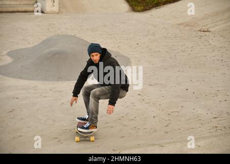 Vaduz, Liechtenstein, November 19, 2021 Guy on a skateboard is performing some cool moves Stock Photo