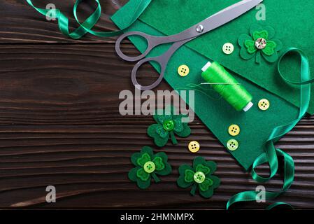 Sewing items for St Patrick decoration flat lay view on wodden table Stock Photo