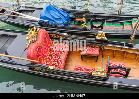 February 2022. Close Up of seats inside a gondola on a canal in Venice Italy Stock Photo