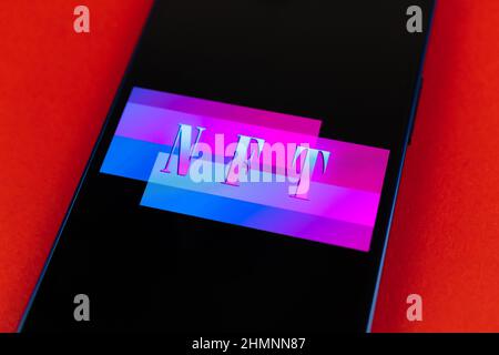 Smartphone with NFT application on abstract red background, top view Stock Photo