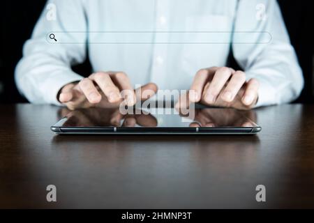 Searching Browsing Internet Data Information with blank search bar.Businessman working with tablet o Stock Photo