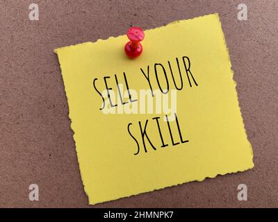 Sell your skill text on yellow torn notepad Stock Photo