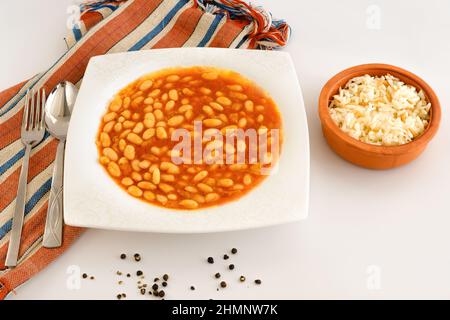 Traditional Turkish food: Kuru Fasulye and Pilav or Haricot Bean and Rice on white background. Meal presentation with traditional food of Turkey. Stock Photo