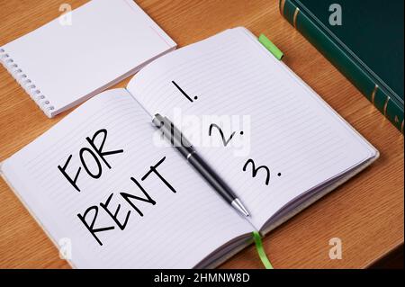 Conceptual display For Rent. Business overview when you make property available for purchasing temporarily Plain Blank Open Notebooks With Stack Of Stock Photo