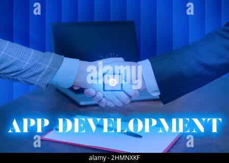 Handwriting text App Development. Internet Concept Development services for awesome mobile and web experiences Man holding Screen Of Mobile Phone Stock Photo