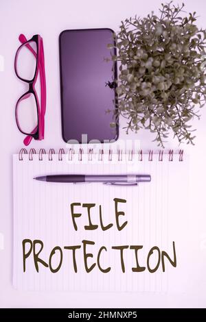 Writing displaying text File Protection. Word for Preventing accidental erasing of data using storage medium Office Supplies Over Desk With Keyboard Stock Photo