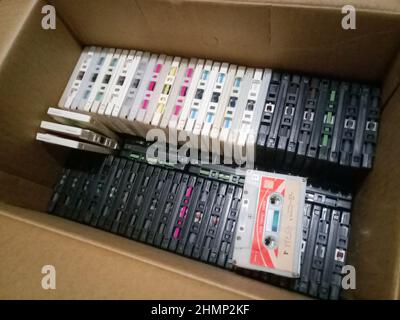 Audio cassette box. Lots of cassettes with film in the box. Stock Photo