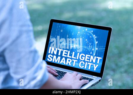 Text caption presenting Intelligent Smart City. Business idea Urban intelligent building automation system business Woman Typing On Laptop In The Park Stock Photo